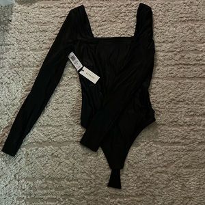 Black body suit  brand new never worn right out of package ordered wrong size